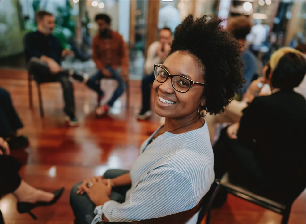 A volunteer smiling in a support group circle
